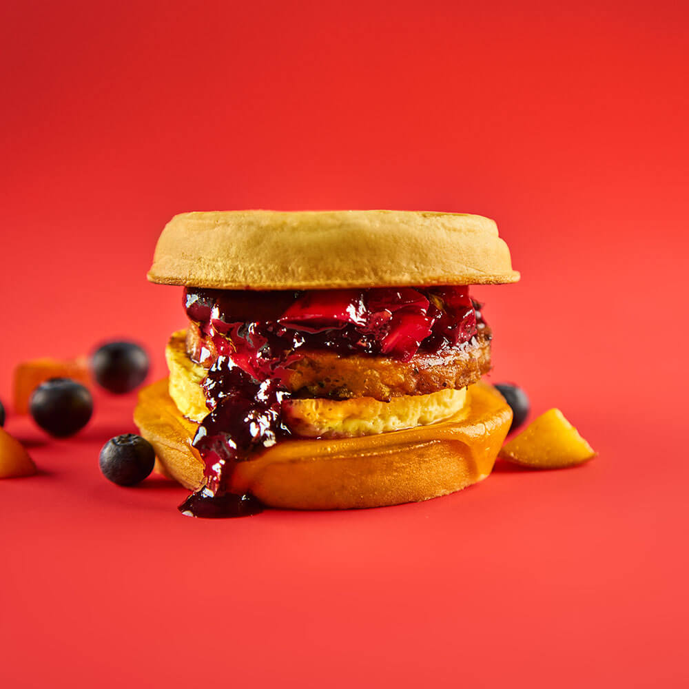 WAFFLE BREAKFAST SANDWICH WITH GARDEIN® SAUS'AGE AND BLUEBERRY, GRILLED PEACH COMPOTE