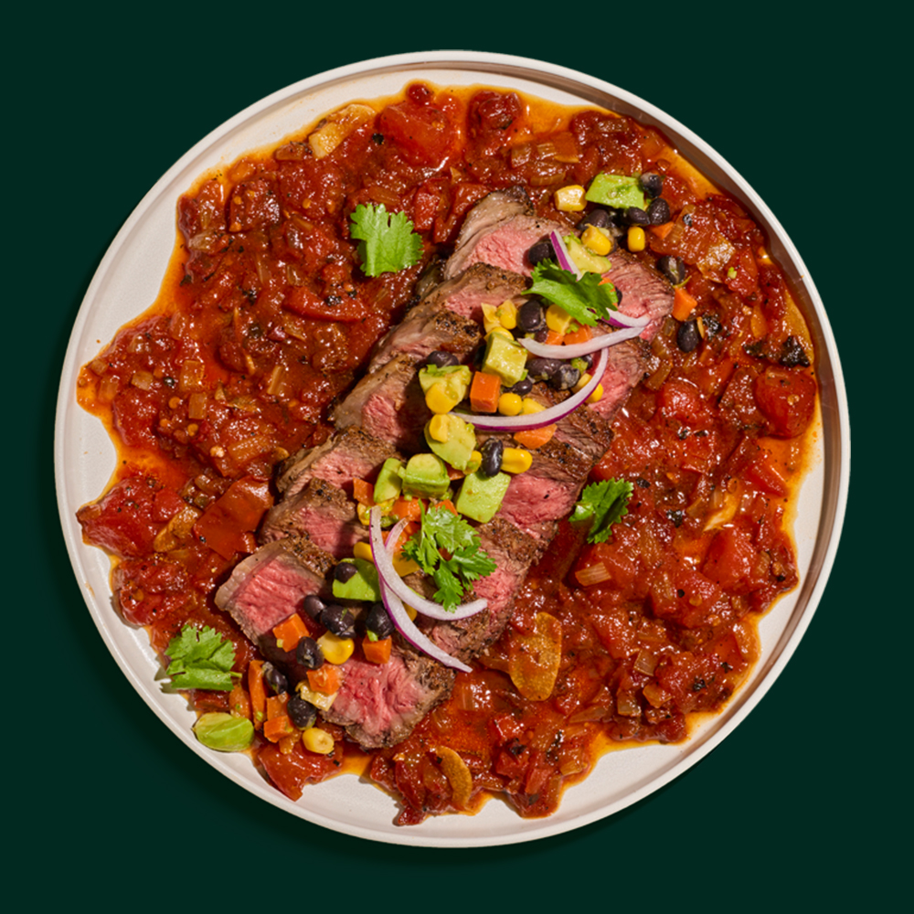 GRILLED STRIP STEAK WITH A SMOKY BBQ TOMATO COMPOTE AND BLACK BEAN AND AVOCADO SALAD